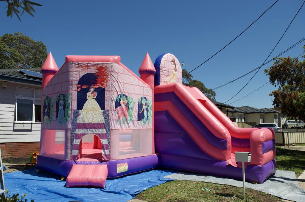 Front of Disney Princess jumping castle with slide