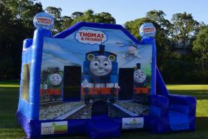 Blue Thomas the Tank Engine jumping castle with slide on the right