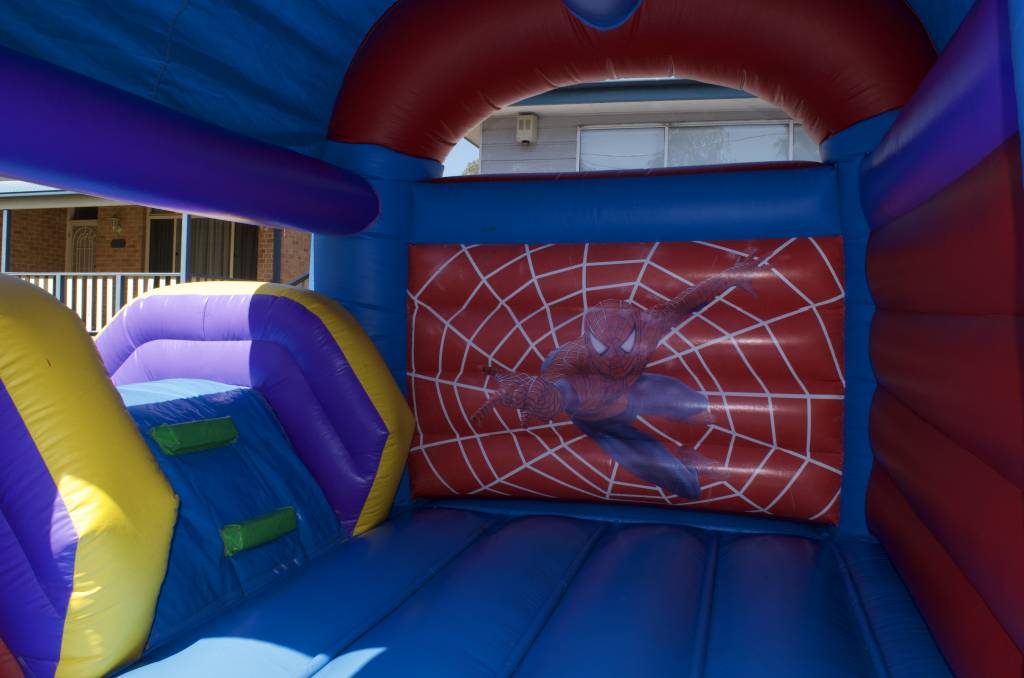 Spider-Man jumping castle with character print on wall