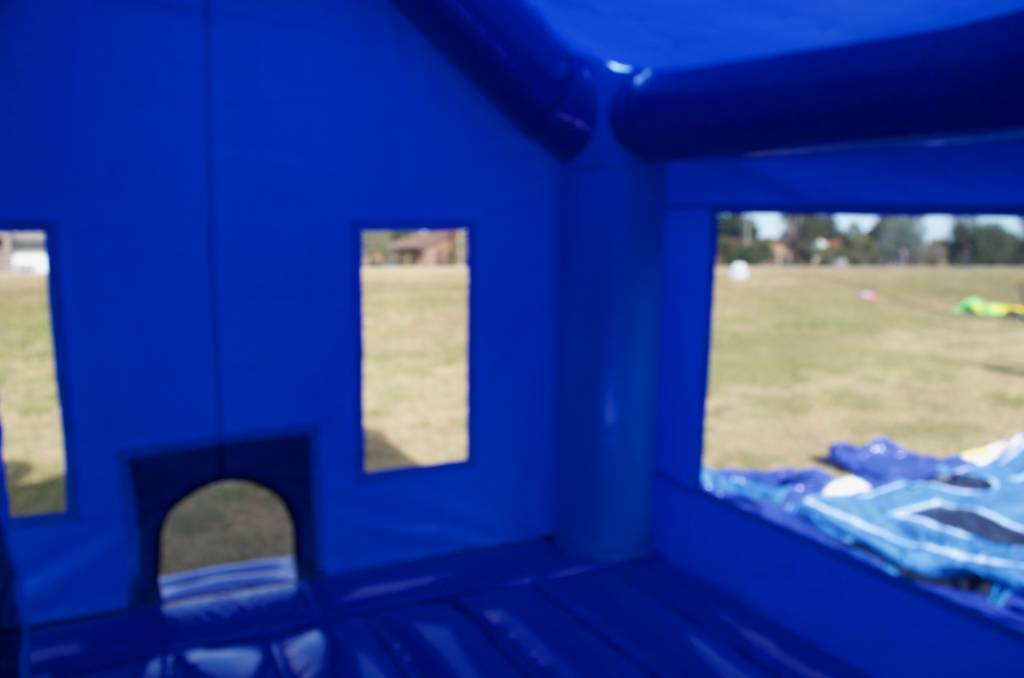Interior of blue jumping castle with windows