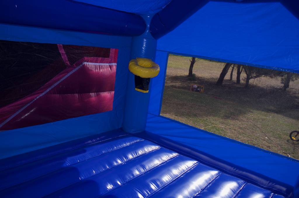 Blue jumping castle interior with basketball hoop
