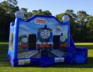 Blue Thomas the Tank Engine jumping castle with slide on the right