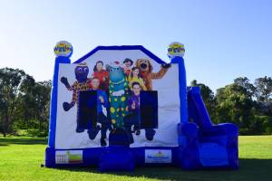 Blue Wiggles jumping castle with slide to the right